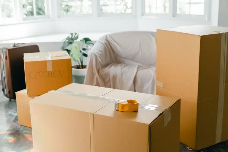 Packed moving boxes in a sunlit living room