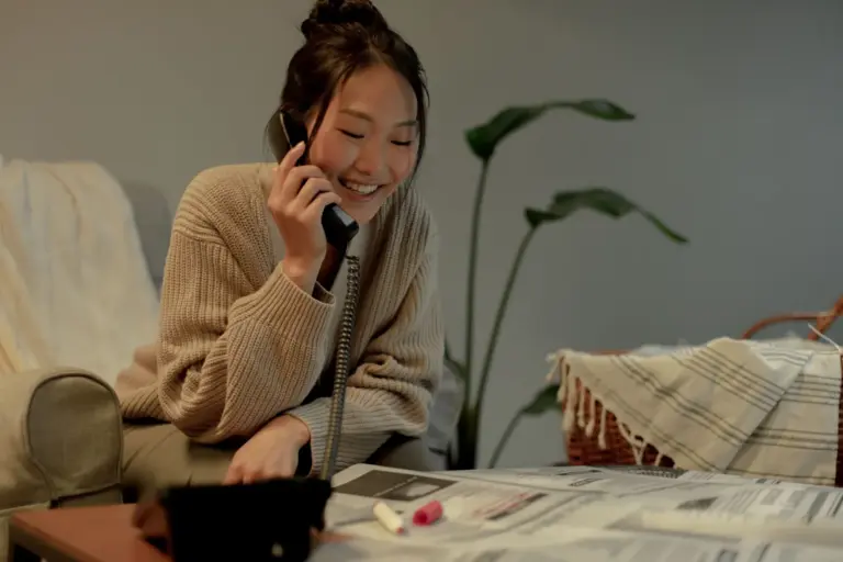 Woman smiling during a phone call at home